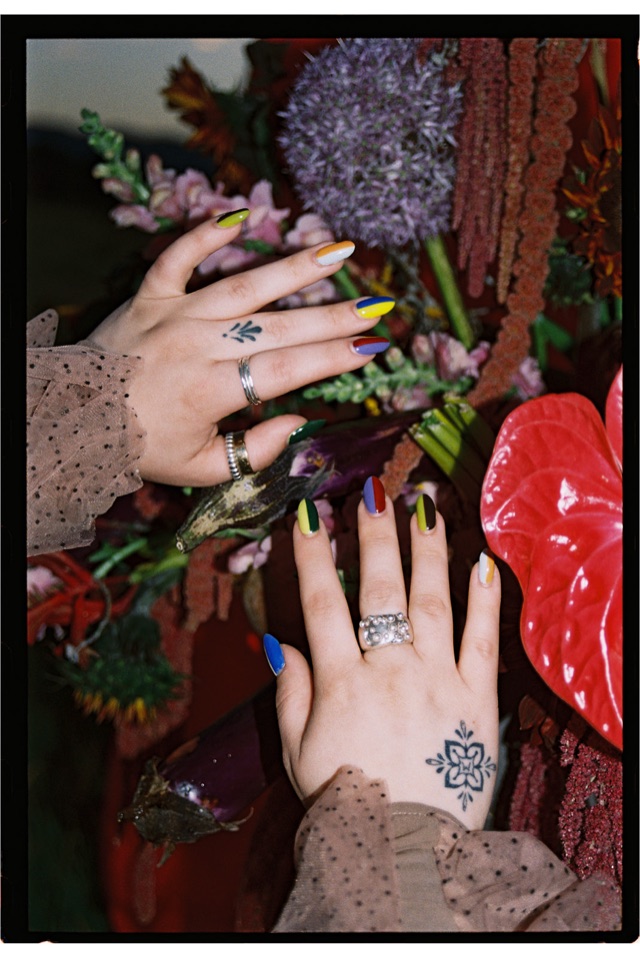 Molly Engels' painted nails among flowers